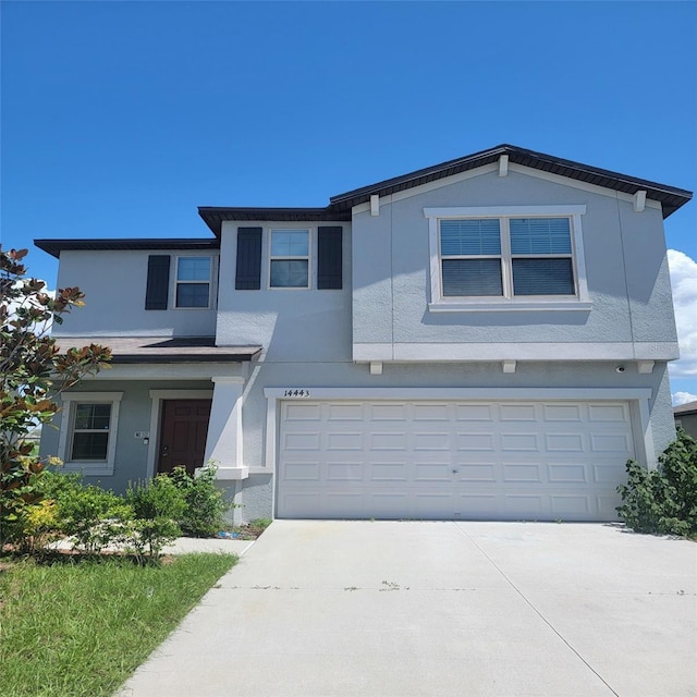 14443 Touch Gold Ln, Sun City Center, FL 33573 - traditional home with stucco siding, concrete driveway, and an attached garage