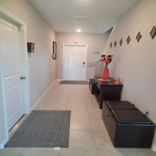 doorway to outside with light tile patterned flooring