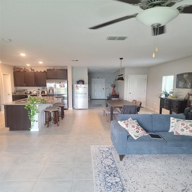 14443 Touch Gold Ln, Sun City Center, FL 33573 - living area with light tile patterned flooring, visible vents, ceiling fan, and recessed lighting