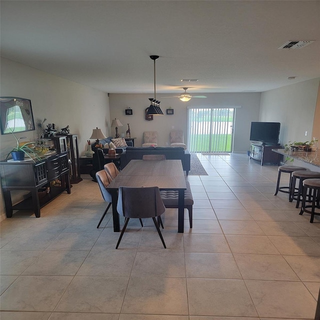 dining area with ceiling fan and light tile patterned floors