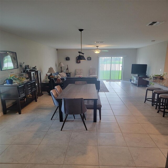 14443 Touch Gold Ln, Sun City Center, FL 33573 - dining room featuring light tile patterned flooring, visible vents, and ceiling fan