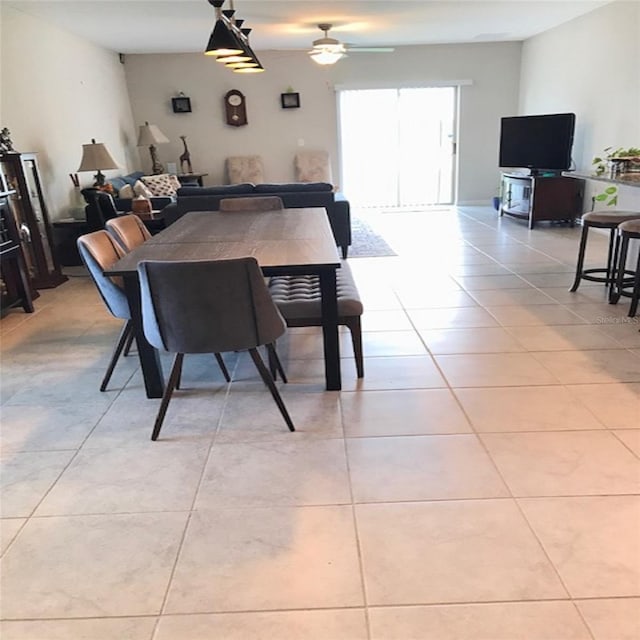 dining space with ceiling fan and light tile patterned floors