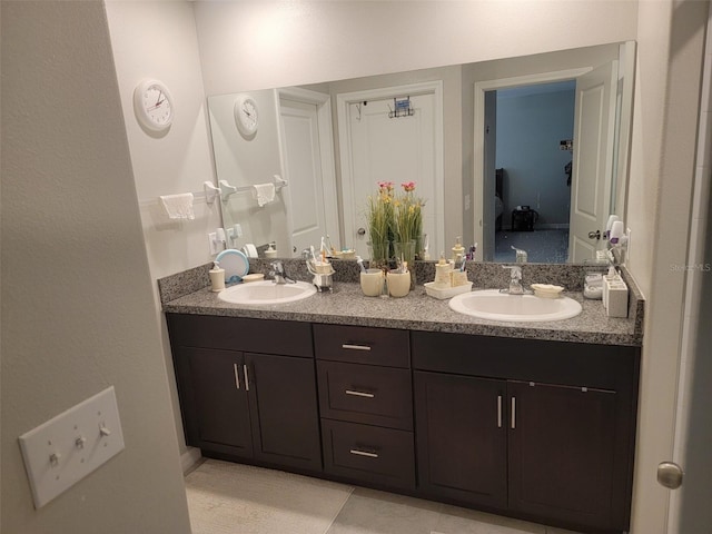 bathroom with dual bowl vanity and tile patterned flooring