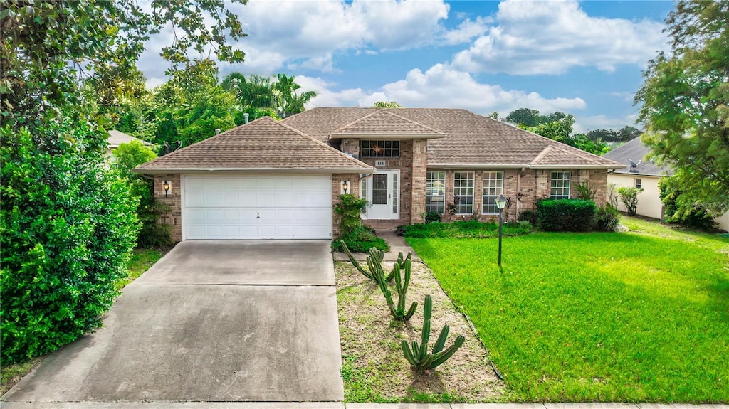 view of front of property with a garage and a front lawn