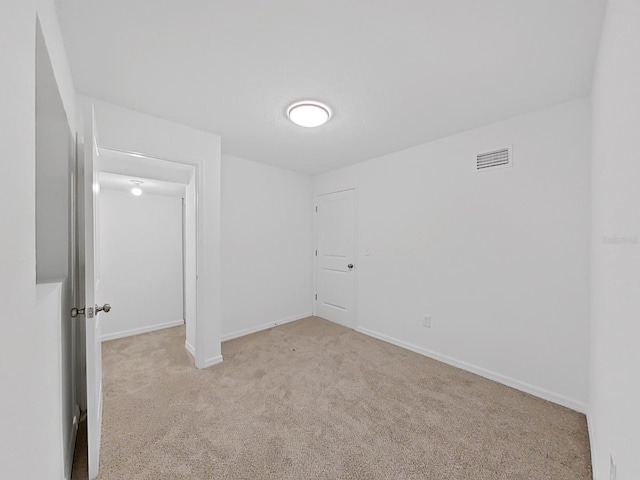 empty room with light colored carpet