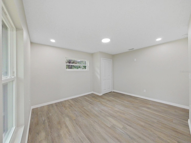 empty room with light hardwood / wood-style floors