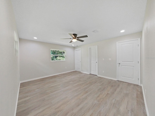 unfurnished room with ceiling fan and light wood-type flooring