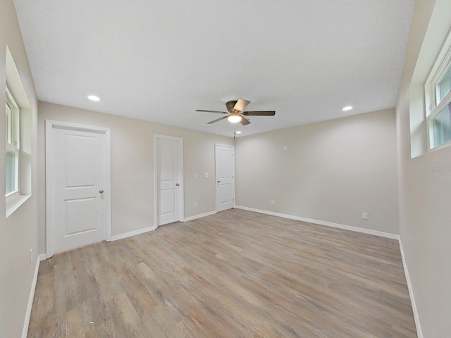 spare room featuring light hardwood / wood-style floors and ceiling fan