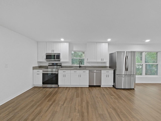 kitchen with white cabinetry, appliances with stainless steel finishes, and sink