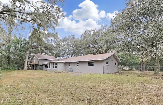 back of house with a lawn