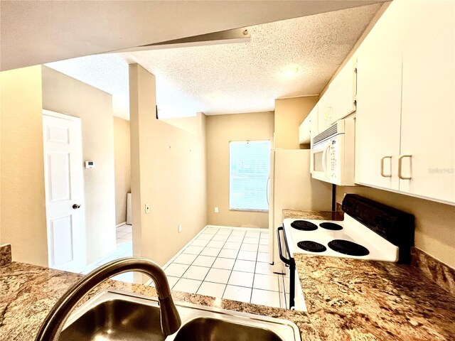 kitchen featuring sink, a textured ceiling, white cabinetry, and white appliances