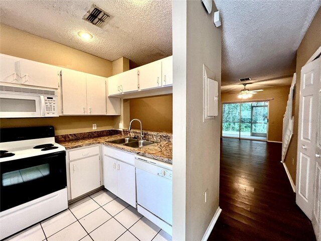 kitchen with light hardwood / wood-style floors, white cabinetry, sink, white appliances, and ceiling fan