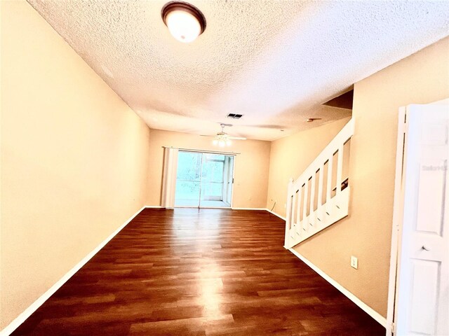 spare room featuring a textured ceiling, ceiling fan, and hardwood / wood-style flooring