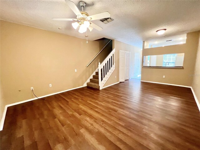 interior space with ceiling fan, sink, wood-type flooring, and a textured ceiling