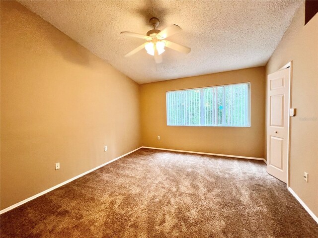 carpeted empty room with a textured ceiling and ceiling fan