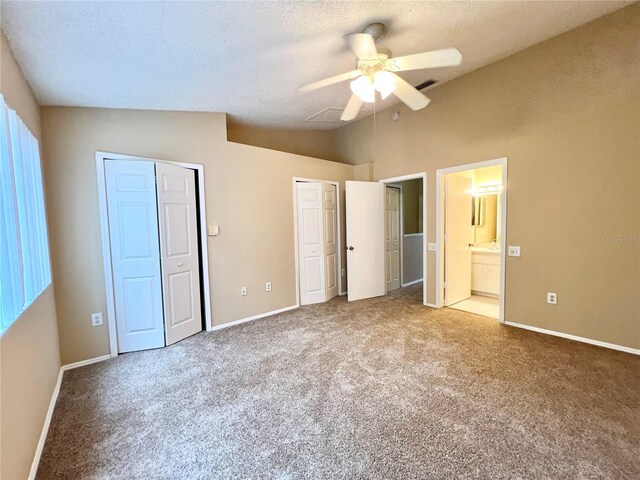 unfurnished bedroom featuring ceiling fan, a textured ceiling, carpet floors, and lofted ceiling