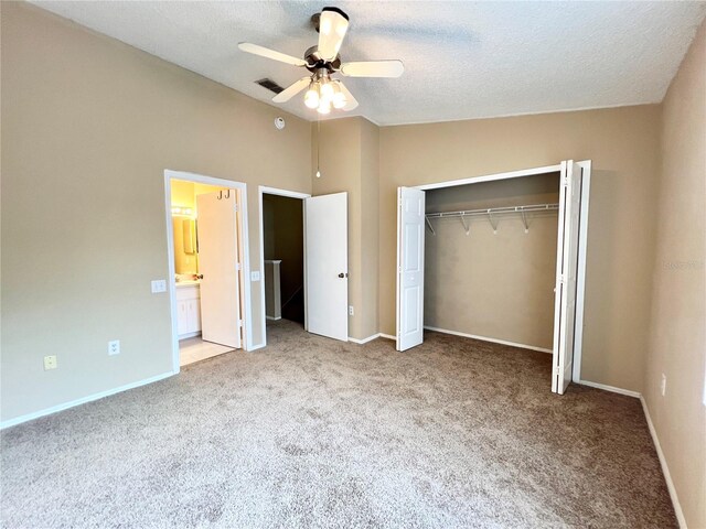 unfurnished bedroom with ceiling fan, a closet, vaulted ceiling, and light carpet