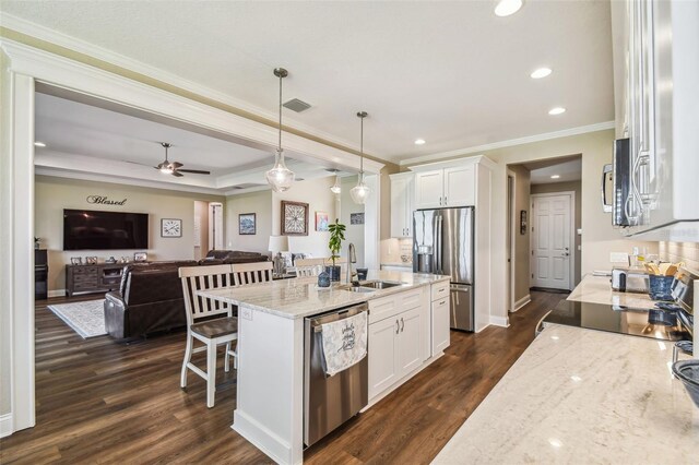 kitchen featuring ornamental molding, dark wood-type flooring, pendant lighting, and stainless steel appliances