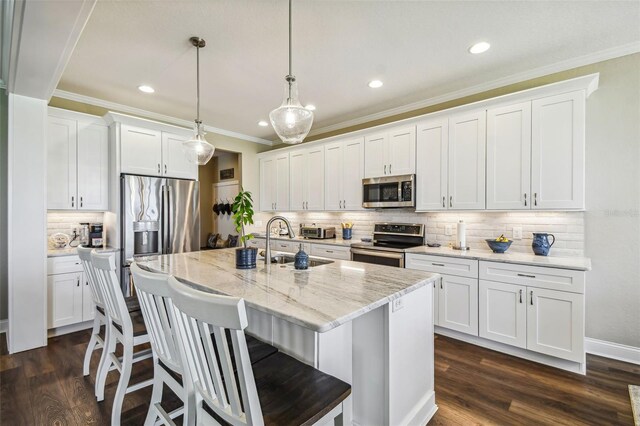 kitchen featuring stainless steel appliances, dark wood-type flooring, decorative backsplash, and white cabinets