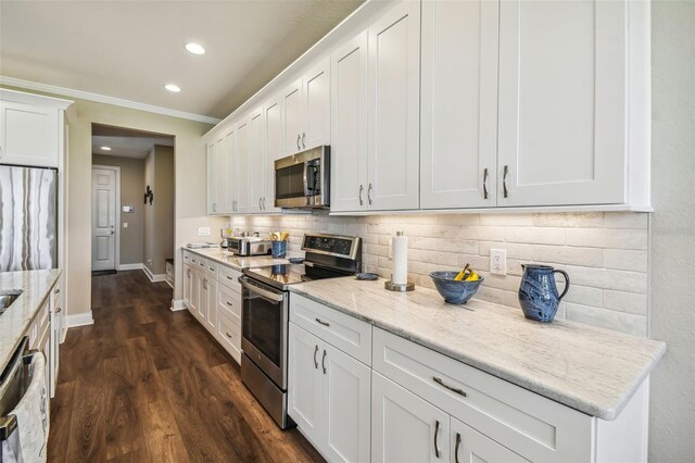 kitchen with stainless steel appliances, decorative backsplash, white cabinetry, ornamental molding, and dark wood-type flooring