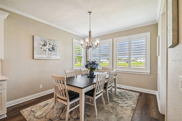 dining space with dark wood-type flooring, an inviting chandelier, and crown molding