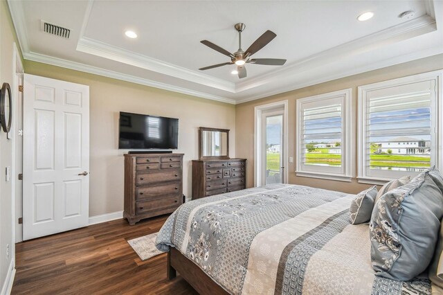 bedroom featuring ceiling fan, a raised ceiling, ornamental molding, and dark hardwood / wood-style floors