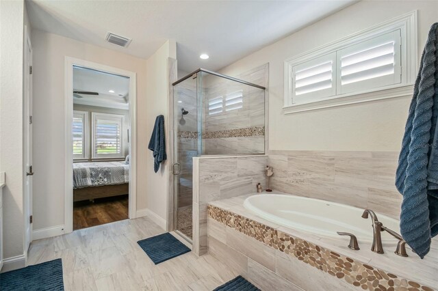 bathroom featuring hardwood / wood-style flooring and shower with separate bathtub