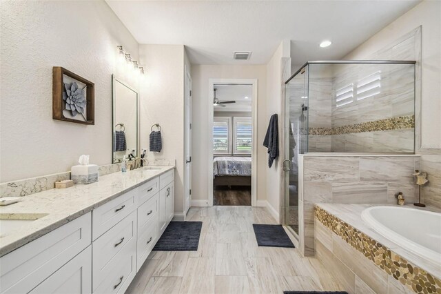 bathroom featuring ceiling fan, double vanity, shower with separate bathtub, and tile patterned floors