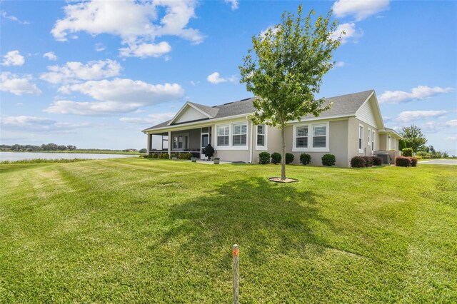 exterior space with a lawn and a water view