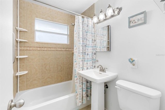 full bathroom featuring toilet and shower / tub combo with curtain