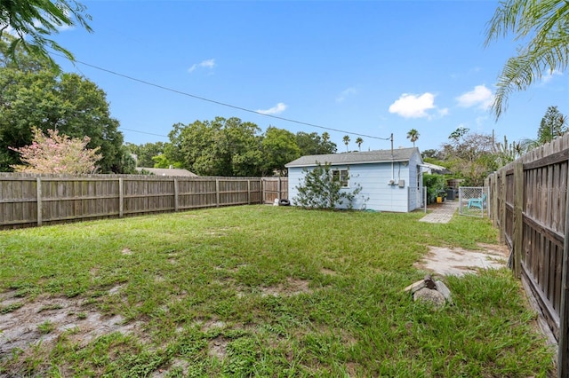 view of yard with an outbuilding and a fenced backyard