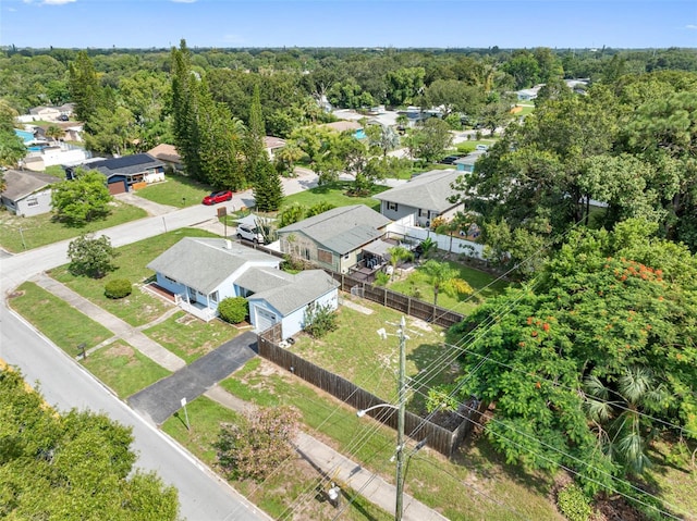 aerial view featuring a wooded view and a residential view