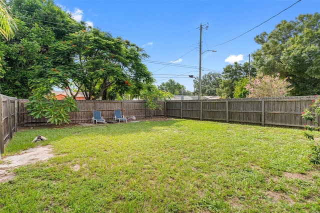 view of yard with a fenced backyard