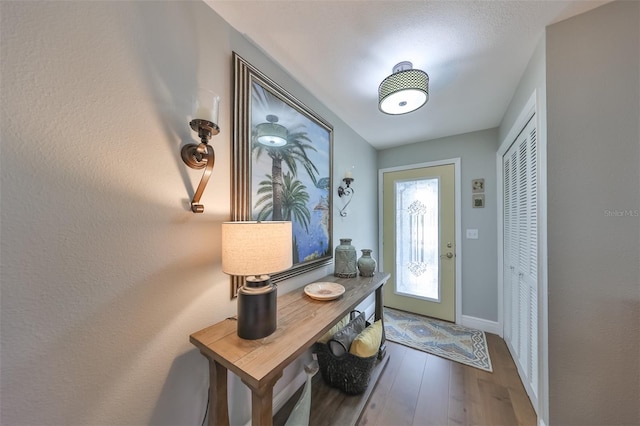 doorway with hardwood / wood-style flooring