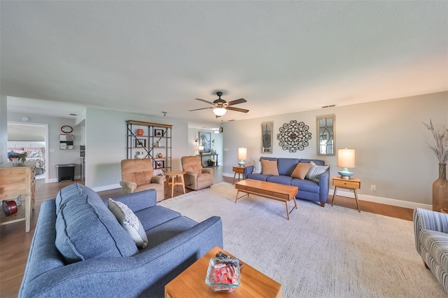 living room featuring hardwood / wood-style floors and ceiling fan