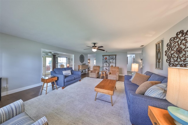 living room with ceiling fan and wood-type flooring