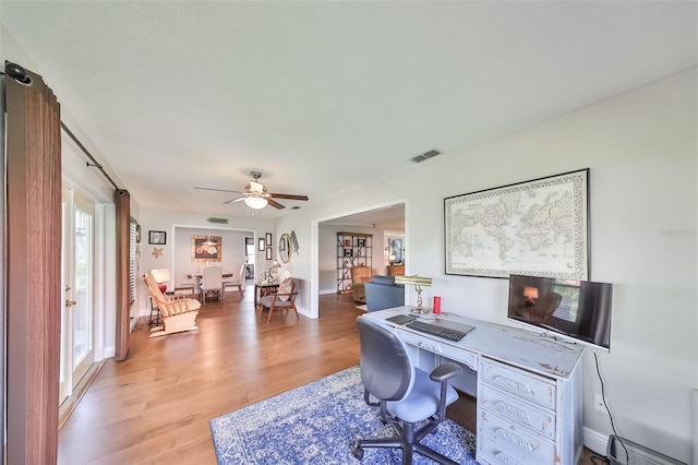 office area with ceiling fan, plenty of natural light, and hardwood / wood-style flooring