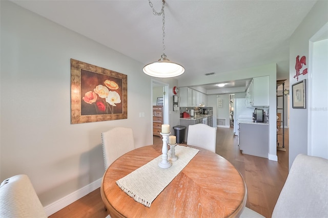 dining area featuring dark hardwood / wood-style floors