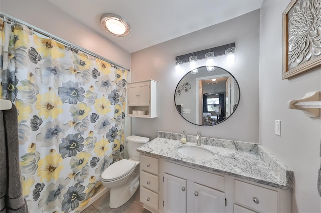 bathroom featuring tile patterned floors, vanity, and toilet