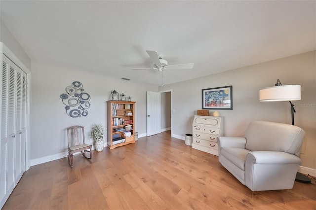 living area featuring ceiling fan and light hardwood / wood-style floors