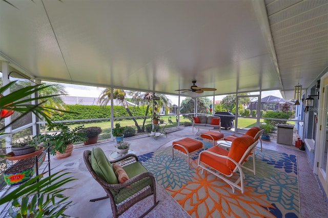 sunroom / solarium featuring ceiling fan