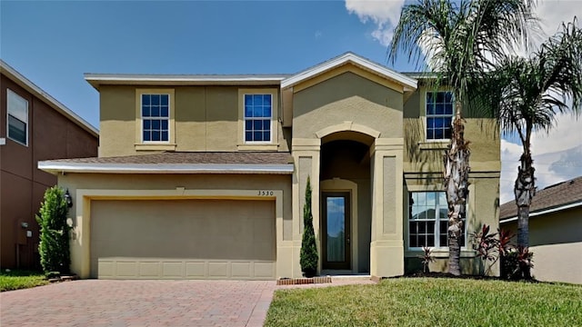 view of front of property with a front lawn and a garage