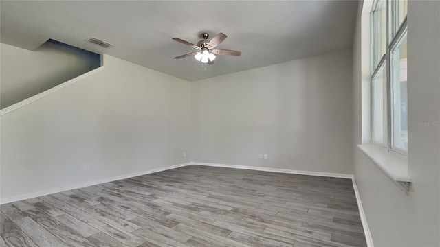 spare room featuring ceiling fan and light hardwood / wood-style floors