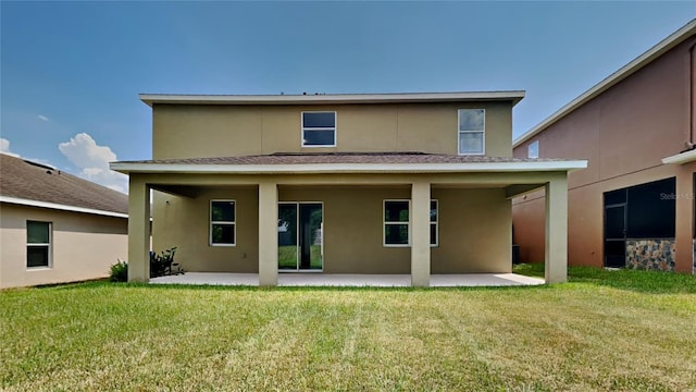 back of property featuring a patio area and a lawn