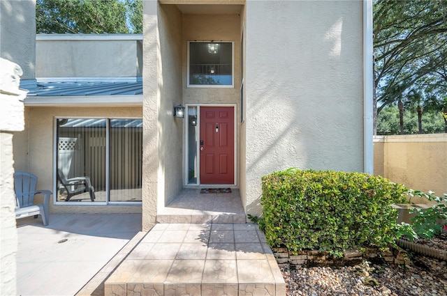 doorway to property featuring stucco siding