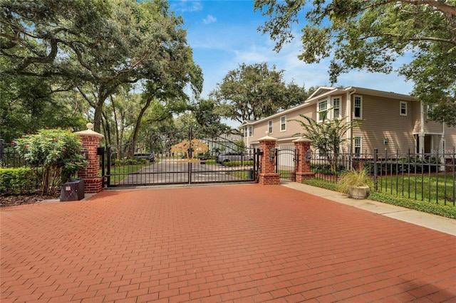 view of gate with a fenced front yard