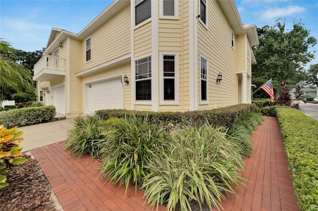 view of property exterior with driveway and an attached garage