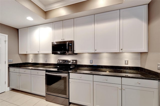 kitchen featuring white cabinetry, tasteful backsplash, appliances with stainless steel finishes, and dark stone countertops