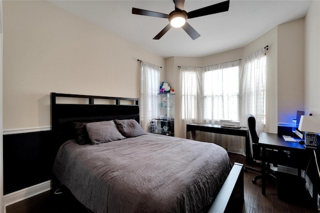 bedroom with dark wood-style flooring, ceiling fan, and baseboards