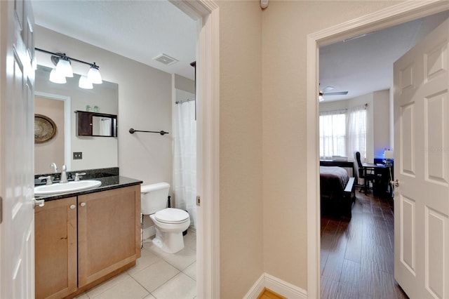 full bathroom with toilet, visible vents, a ceiling fan, vanity, and tile patterned floors